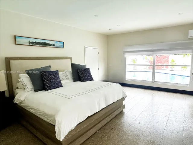 a bedroom with bed and window