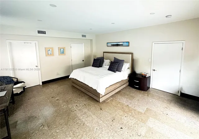 a bedroom with a bed and a table in it