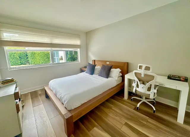 a bedroom with a bed and a desk