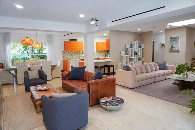 a living room with furniture fireplace and a large window