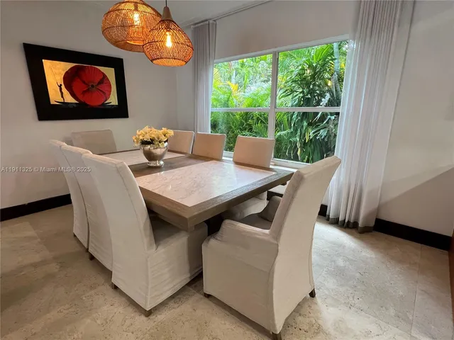 a dining room with furniture and window
