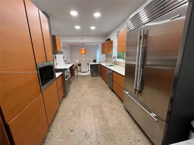 a kitchen with stainless steel appliances a refrigerator and a stove