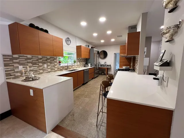 a kitchen with stainless steel appliances a sink stove and refrigerator