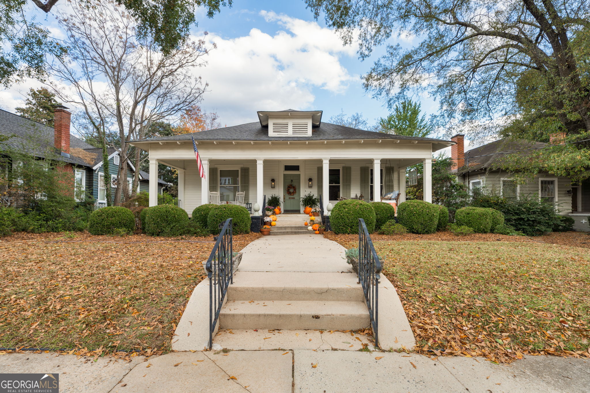 a front view of a house with a garden