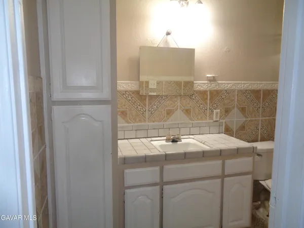 a bathroom with a sink and vanity