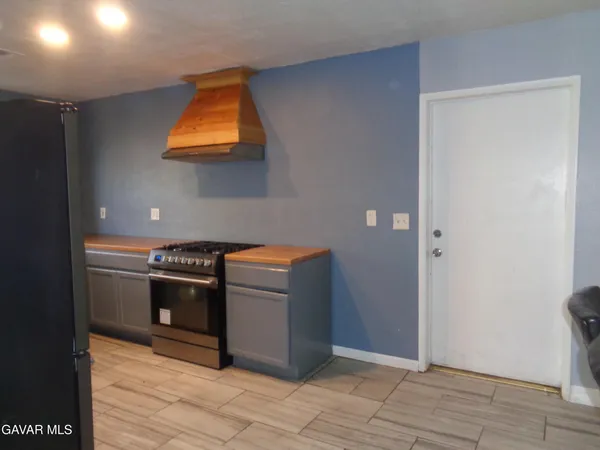 a kitchen with stainless steel appliances granite countertop a refrigerator and a stove