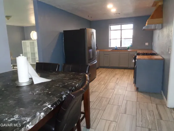 a kitchen with a sink stove and refrigerator