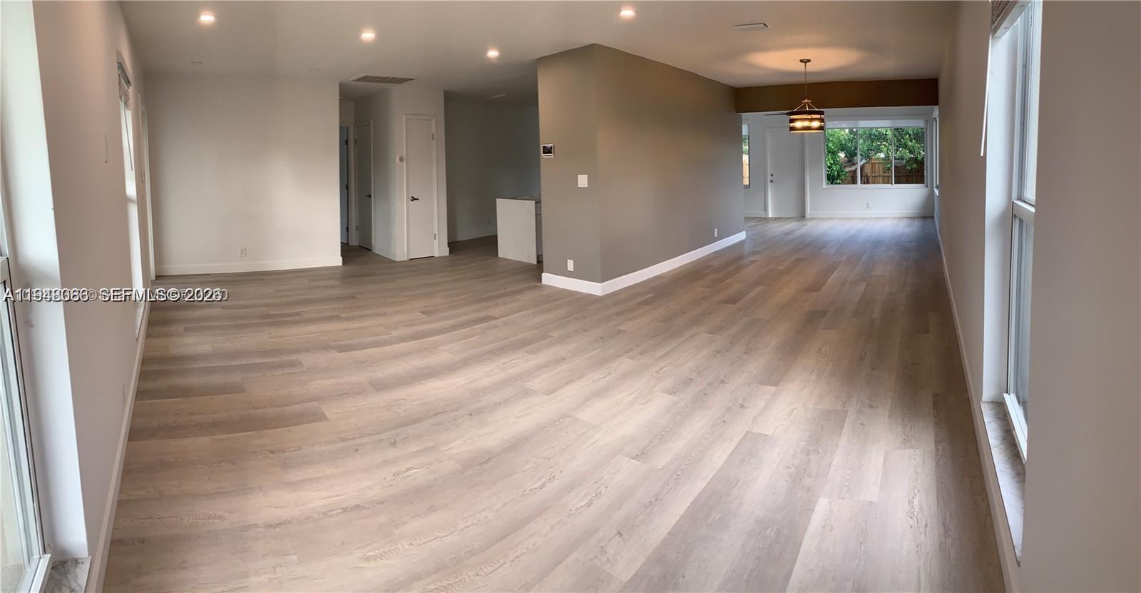 227 Southeast 7th Street Dania Beach, FL 33004 - Photo 11 of 13 wooden floor in an empty room with a window