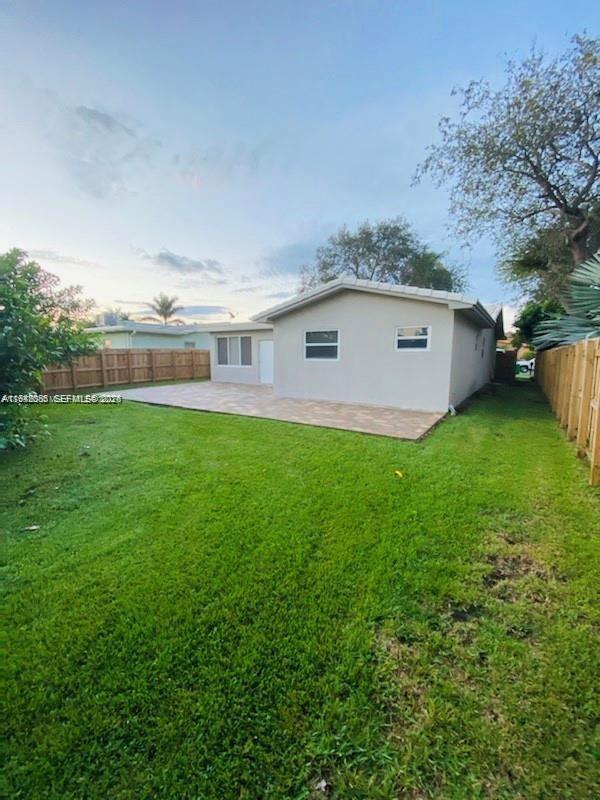 227 Southeast 7th Street Dania Beach, FL 33004 - Photo 12 of 13 a view of a backyard with plants and large trees