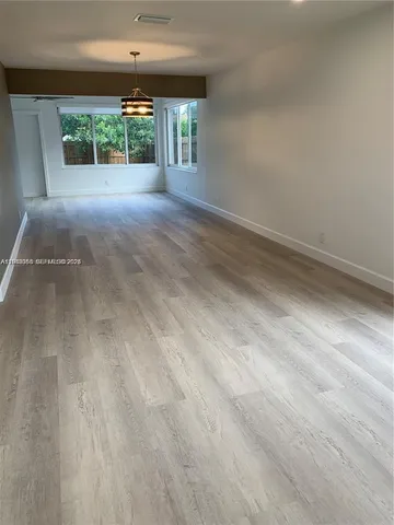 a view of a room with a floor to ceiling window and garden view