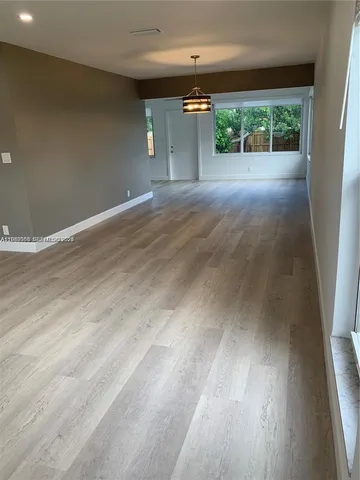 a view of a room with a floor to ceiling window and a yard