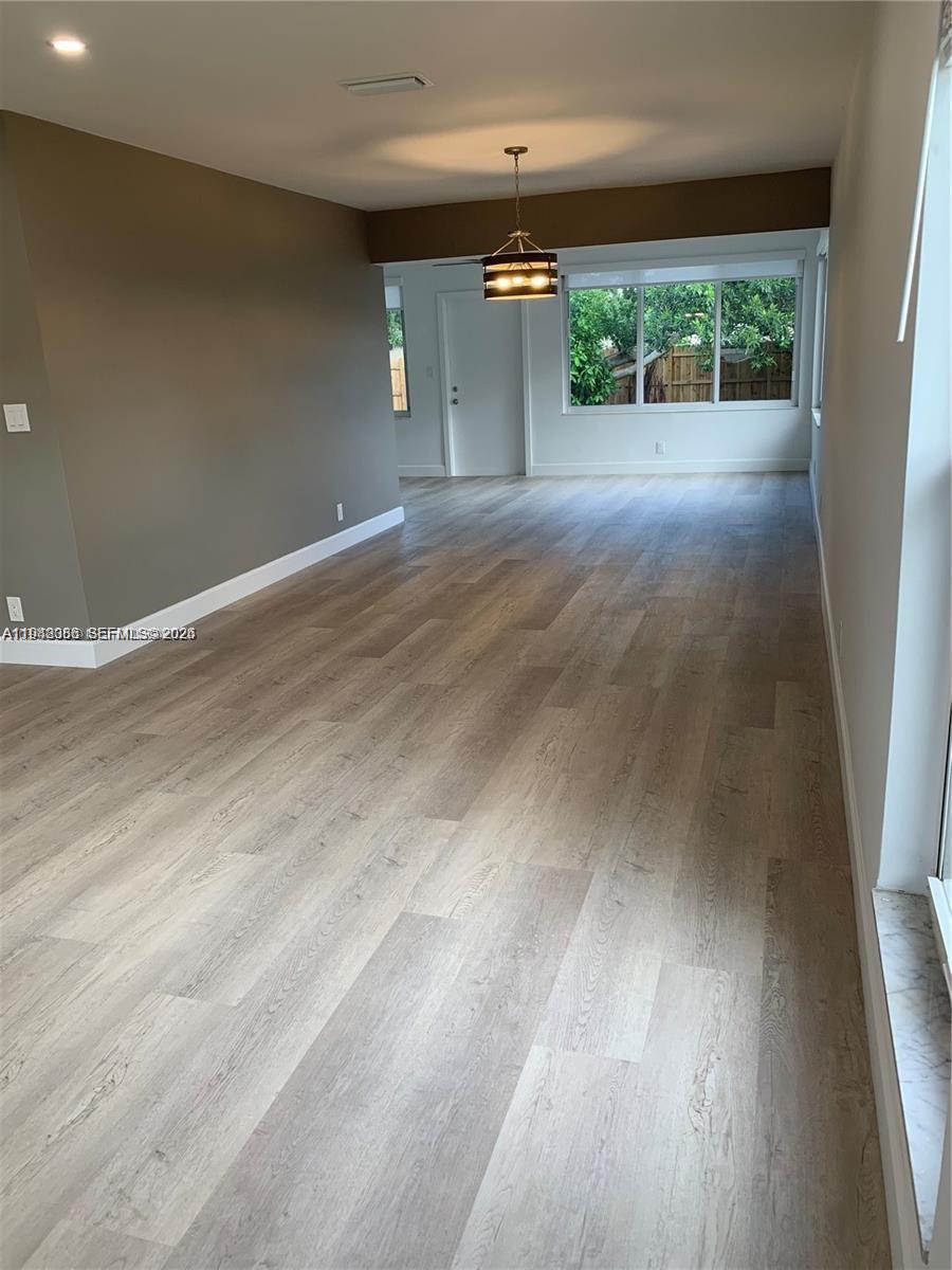 227 Southeast 7th Street Dania Beach, FL 33004 - Photo 8 of 13 a view of a room with a floor to ceiling window and a yard