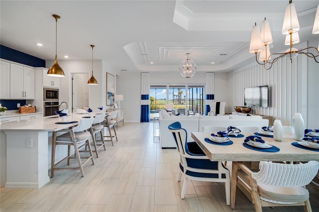 7165 Inlet Isles Lakewood Ranch, FL 34202 - Photo 13 of 26 a dinning room and kitchen with furniture