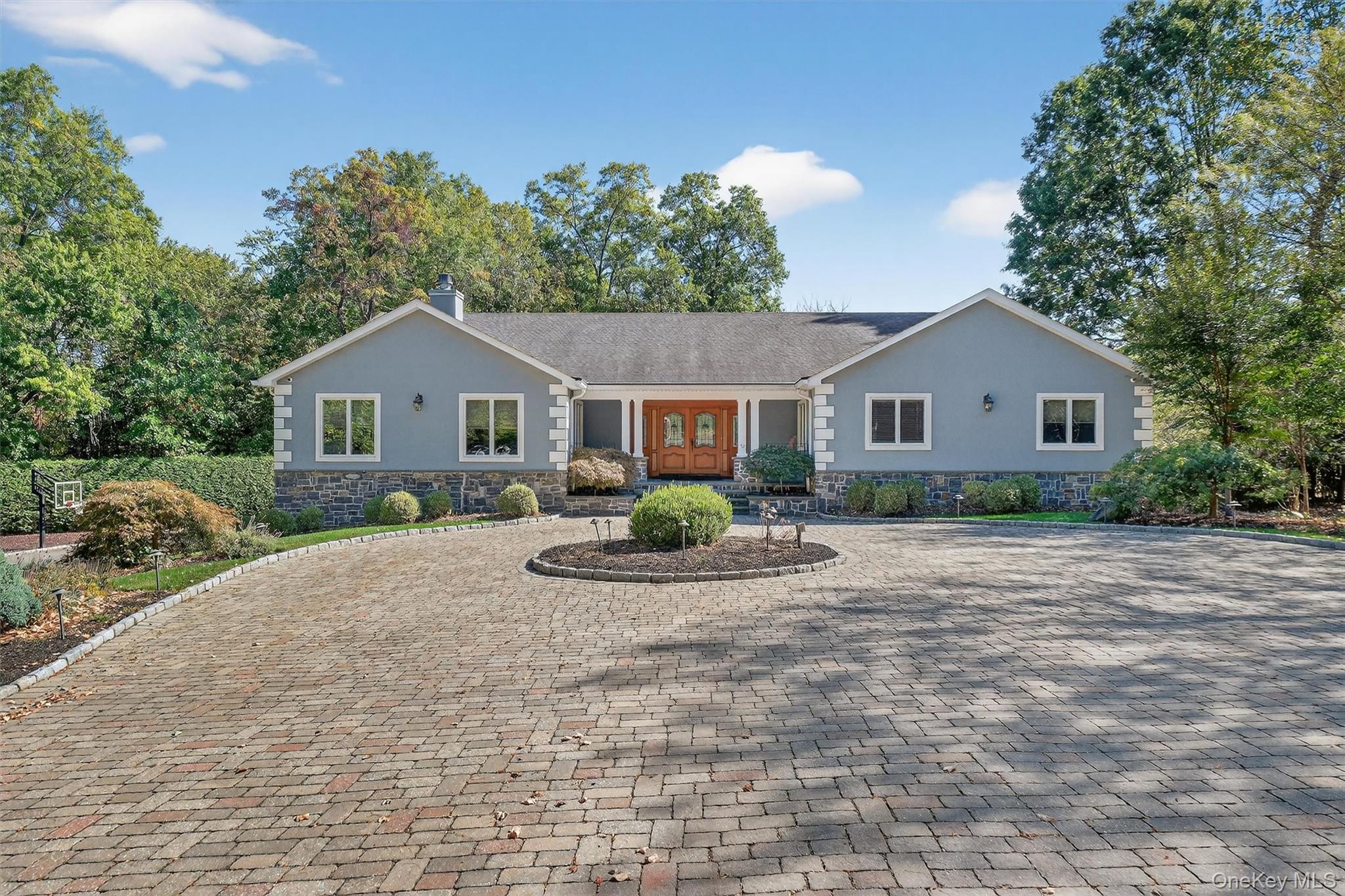 a front view of a house with a yard outdoor seating and garage