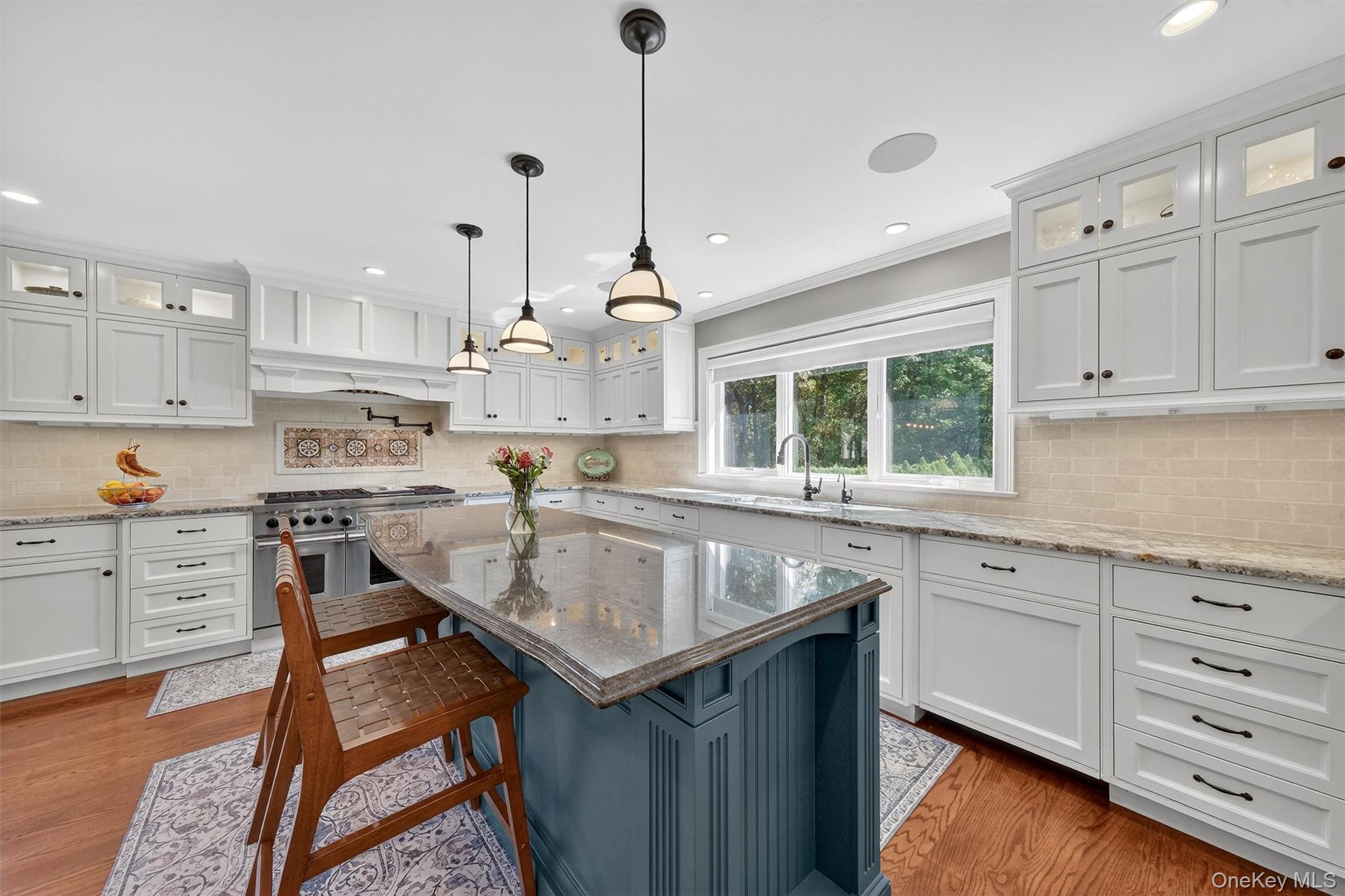 5 Stonehaven Road West Nyack, NY 10994 - Photo 11 of 50 Kitchen with glass insert cabinets, decorative backsplash, light stone counters, a breakfast bar area, and recessed lighting