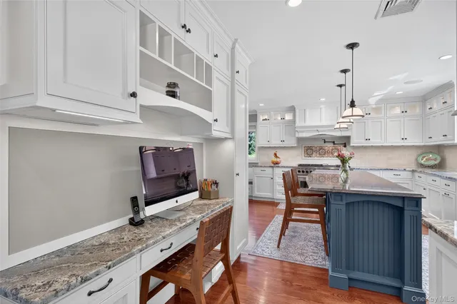 a bathroom with a sink vanity mirror and toilet