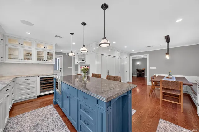 a spacious bedroom with a bed and wooden floor