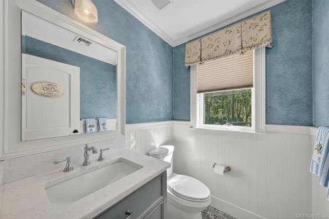 a bathroom with a double vanity sink mirror and bathtub