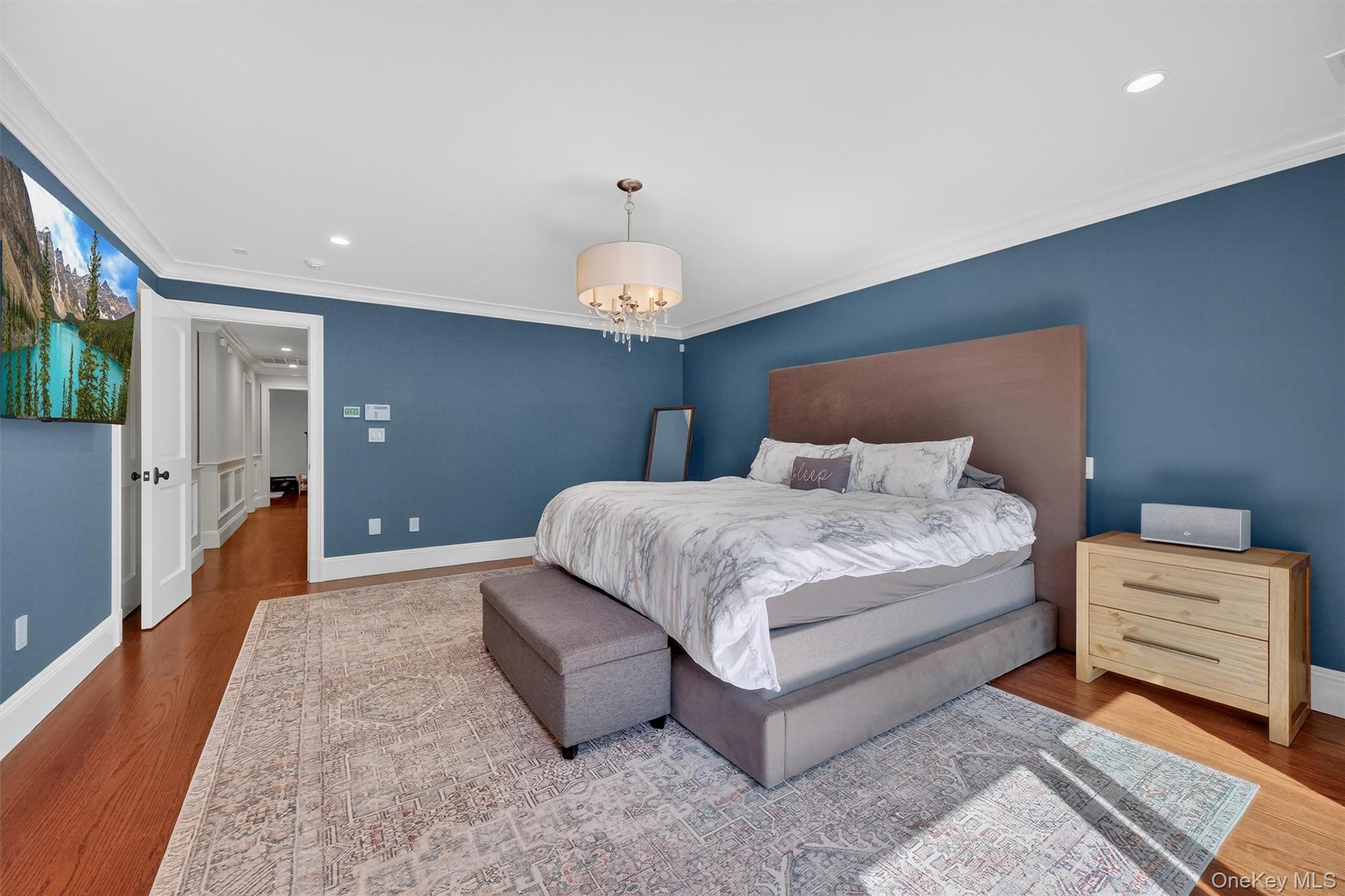 5 Stonehaven Road West Nyack, NY 10994 - Photo 18 of 50 a bedroom with a bed and a chandelier