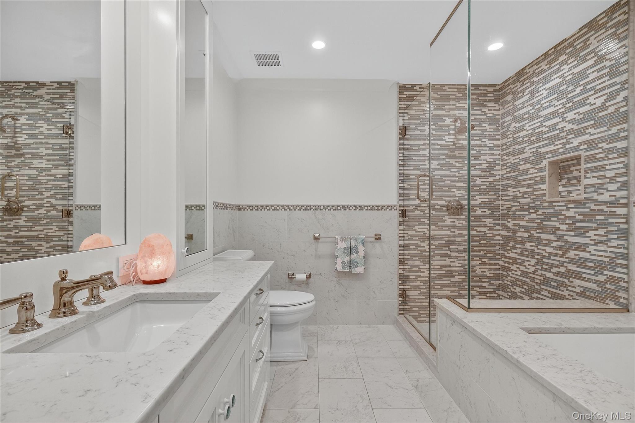 5 Stonehaven Road West Nyack, NY 10994 - Photo 25 of 50 Bathroom featuring tile walls, vanity, recessed lighting, a stall shower, and a wainscoted wall