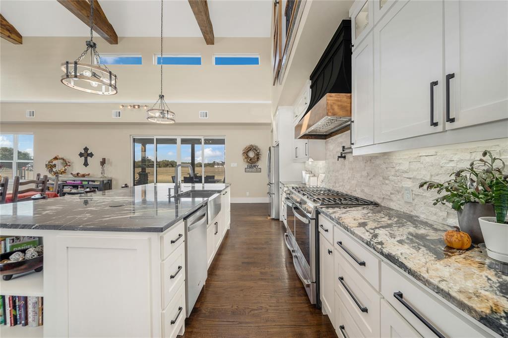 3106 County Road 2526 Quinlan, TX 75474 - Photo 8 of 37 a kitchen with stainless steel appliances granite countertop a sink and stove