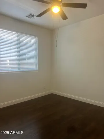 a bathroom with a granite countertop bathtub shower sink vanity and toilet