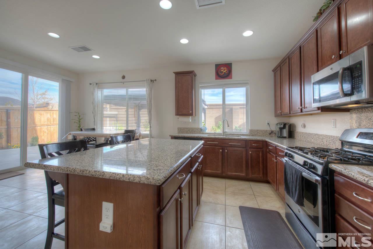 2180 Hope Valley Drive Reno, NV 89521 - Photo 7 of 21 a kitchen with stainless steel appliances granite countertop a sink stove and cabinets