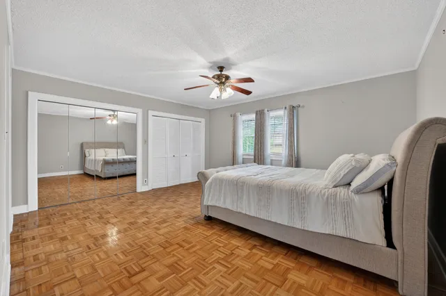 a spacious bedroom with a bed and a chandelier