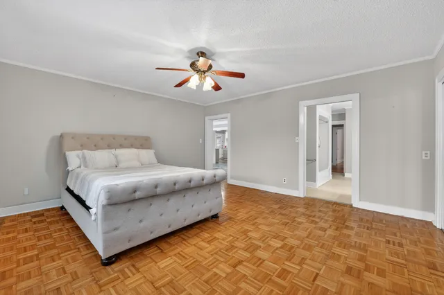 a bedroom with a bed and a chandelier