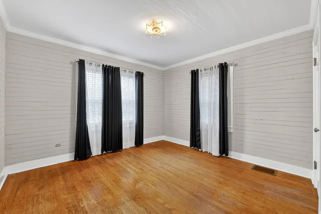 a bedroom with a bed and a potted plant