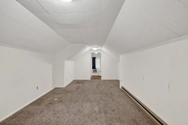 a view of a big room with windows and ceiling fan