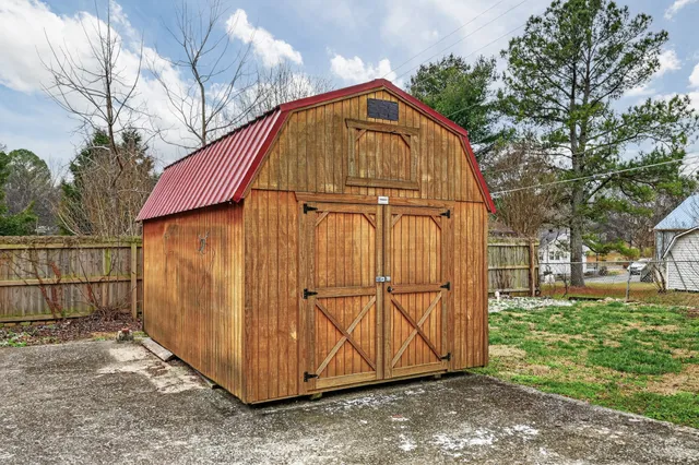 a view of backyard with small cabin