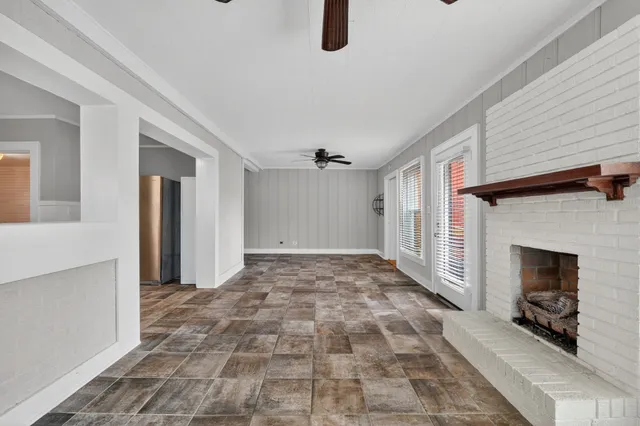 a view of a livingroom with a fireplace and window