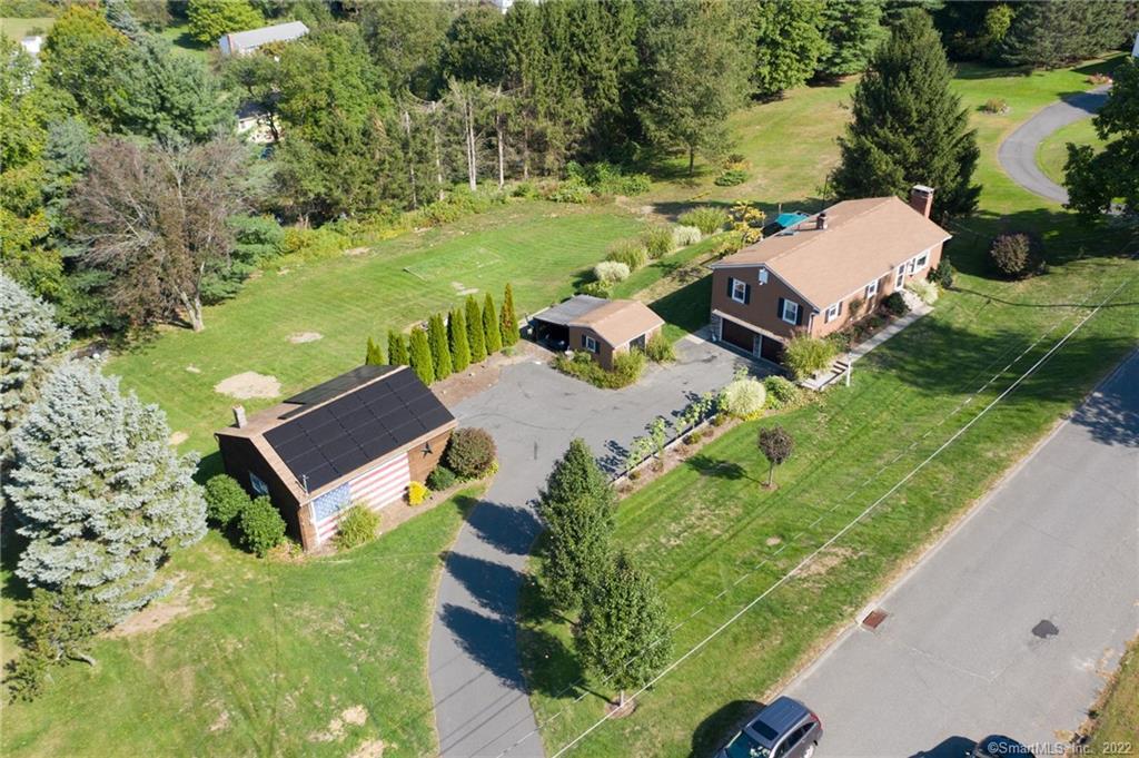 Aerial view of home plus large barn.