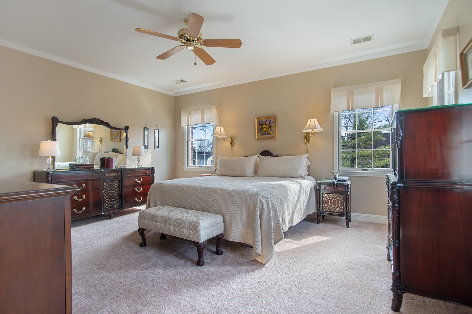 415 Elmore Street Park Ridge, IL 60068 - Photo 22 of 38 a spacious bedroom with a bed and a chandelier