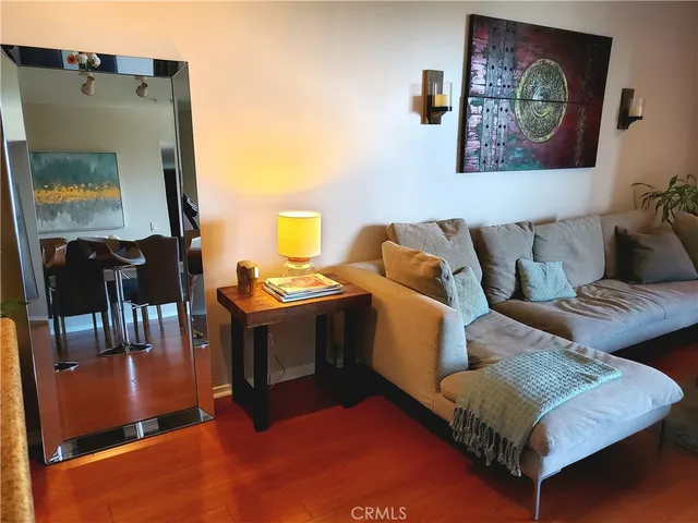 a living room with furniture and a mirror