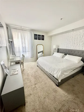 a bedroom with a large bed and a window