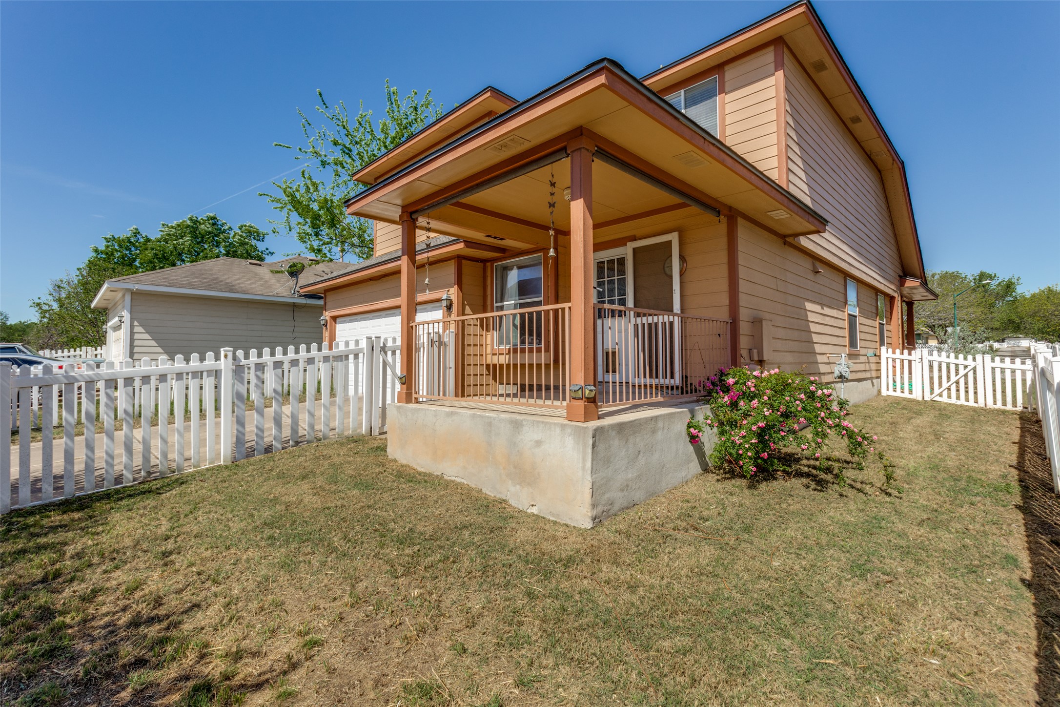 5043 Hartson Kyle, TX 78640 - Photo 24 of 30 Rear view of house featuring a garage and a porch