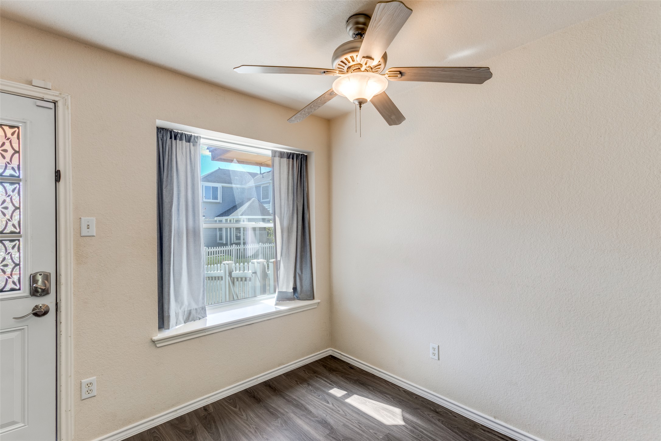 5043 Hartson Kyle, TX 78640 - Photo 9 of 30 Dining area featuring ceiling fan, dark wood-style floors, and a textured wall