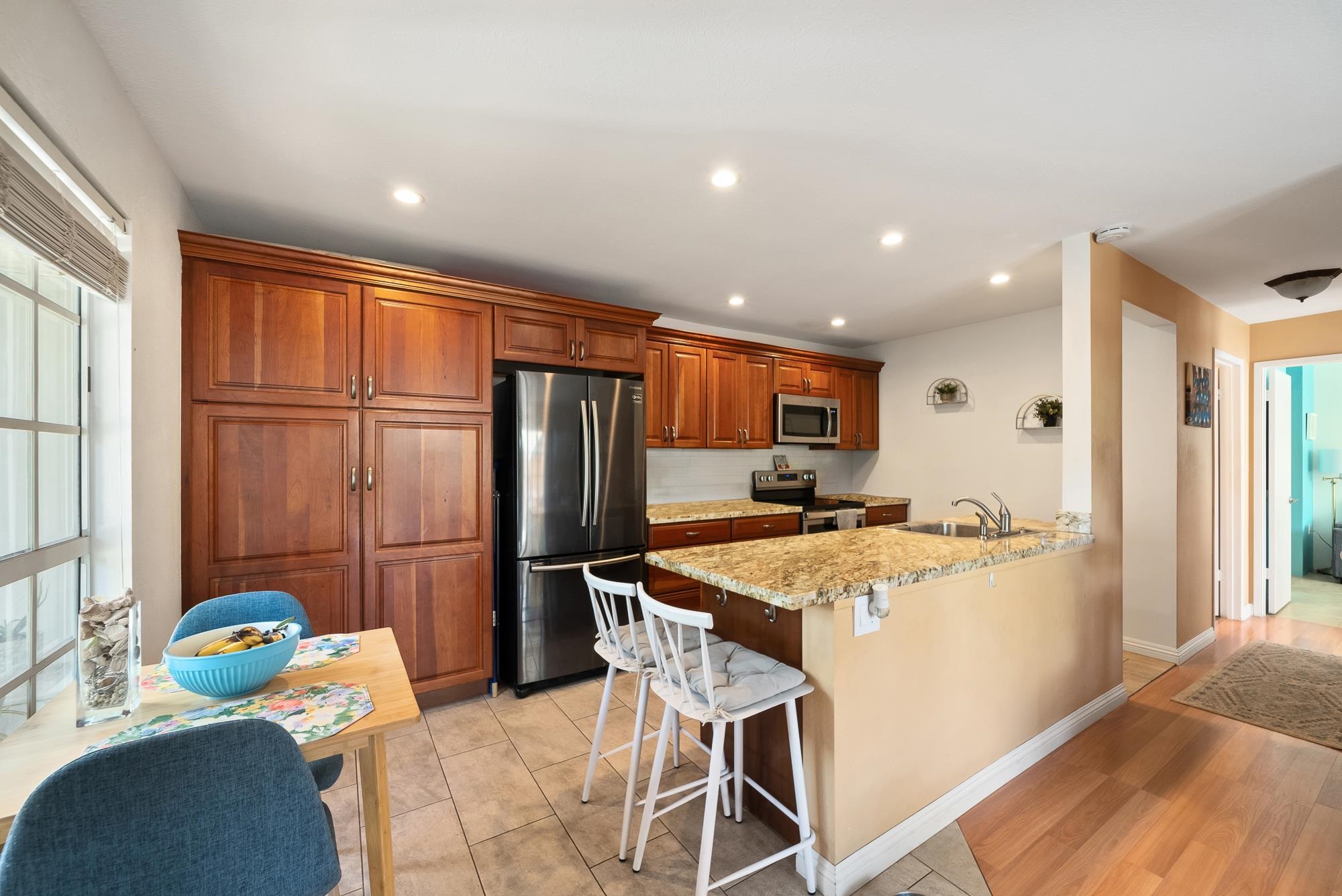 160 Keonekai Road, Unit 9101 Kihei, HI 96753 - Photo 1 of 23 a kitchen with stainless steel appliances kitchen island granite countertop a refrigerator and a stove top oven