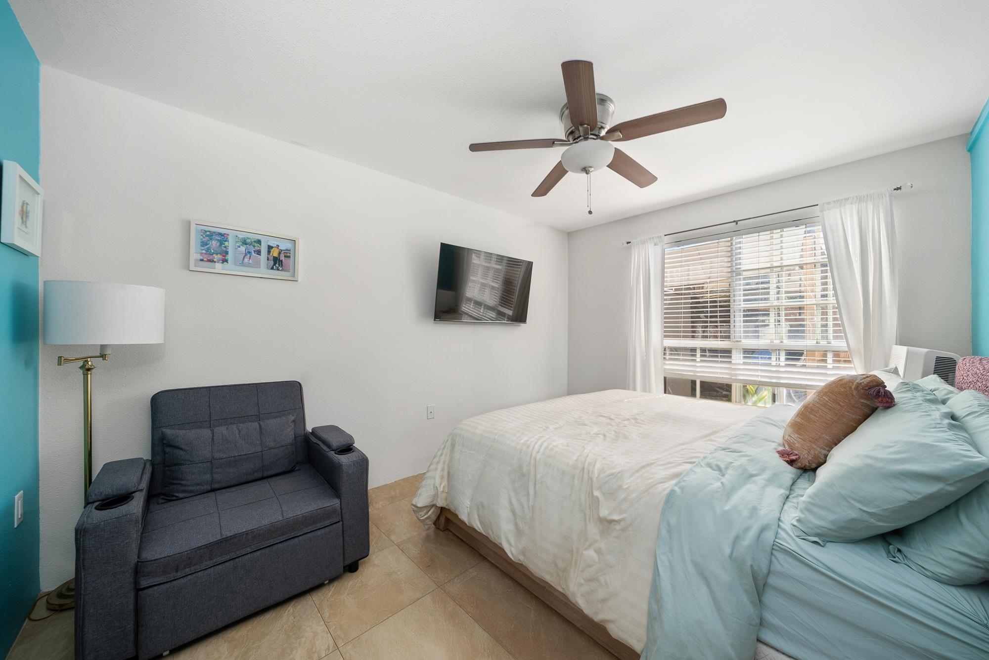 160 Keonekai Road, Unit 9101 Kihei, HI 96753 - Photo 13 of 23 a bedroom with a bed couches and window