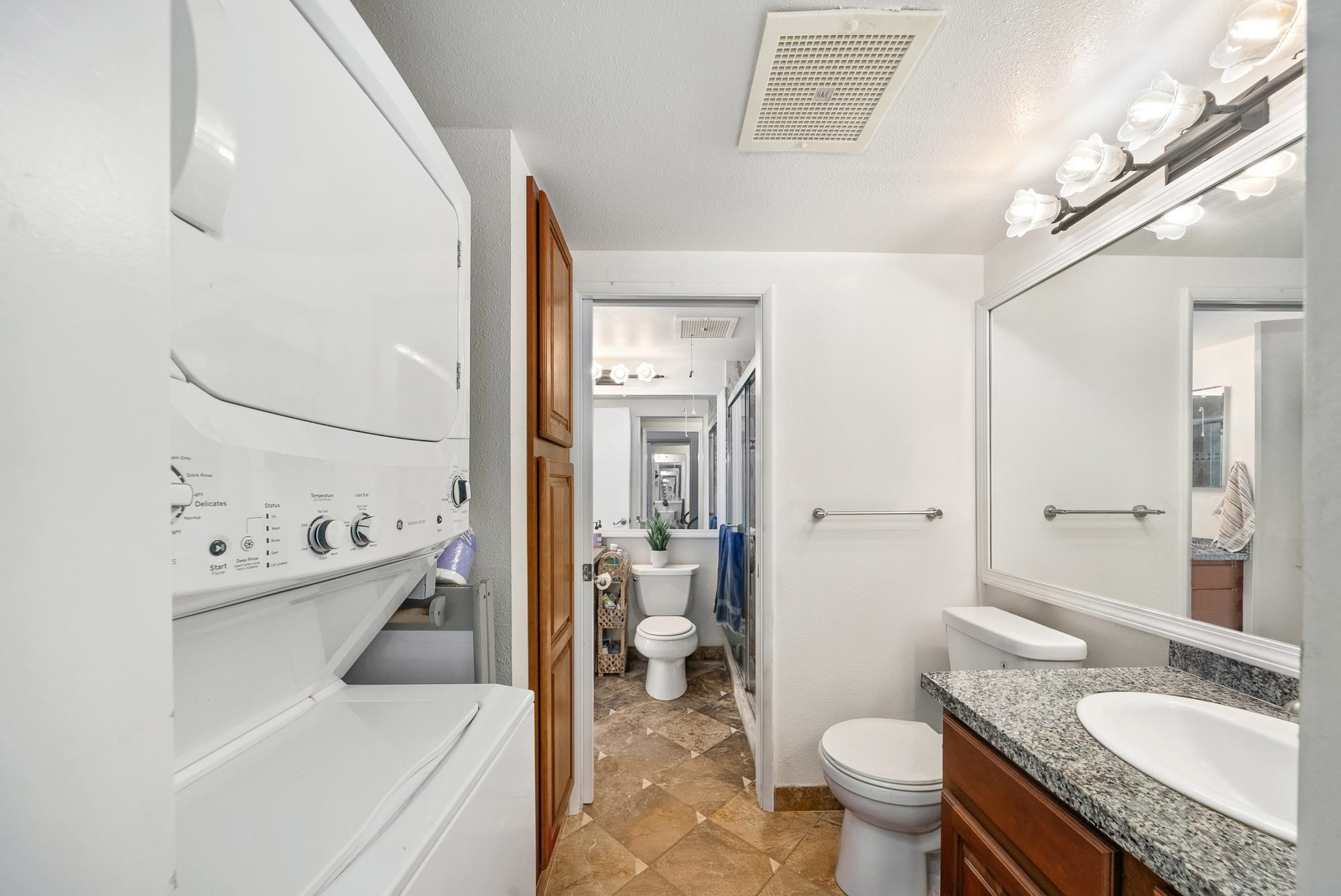 160 Keonekai Road, Unit 9101 Kihei, HI 96753 - Photo 15 of 23 a bathroom with a granite countertop sink toilet and shower