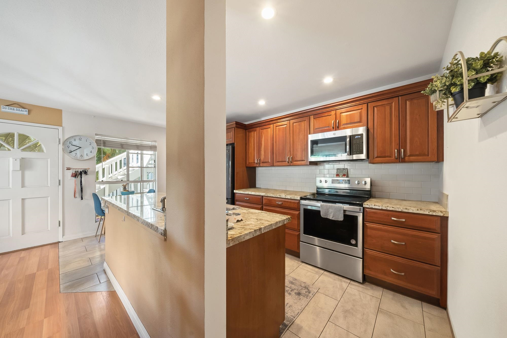 160 Keonekai Road, Unit 9101 Kihei, HI 96753 - Photo 7 of 23 a kitchen with stainless steel appliances granite countertop wooden cabinets a stove top oven a sink and dishwasher