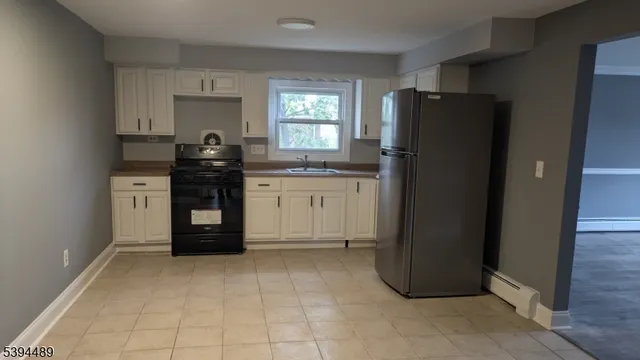 a kitchen with granite countertop a refrigerator and a stove
