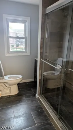 a bathroom with a toilet and a shower