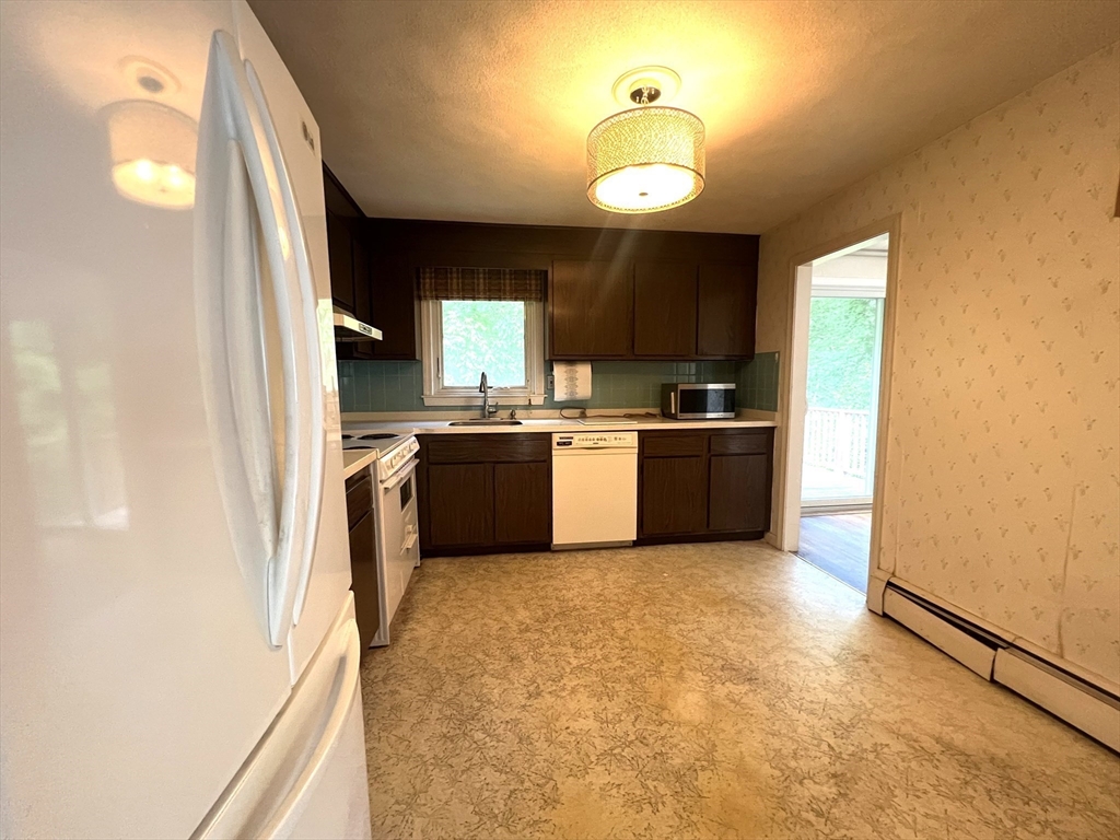 31 Dix Rd Extension Woburn, MA 01801 - Photo 8 of 22 a kitchen with cabinets a sink and appliances