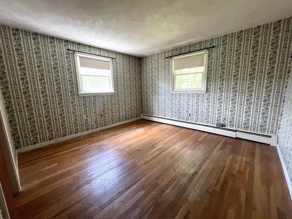 31 Dix Rd Extension Woburn, MA 01801 - Photo 9 of 22 an empty room with wooden floor and windows