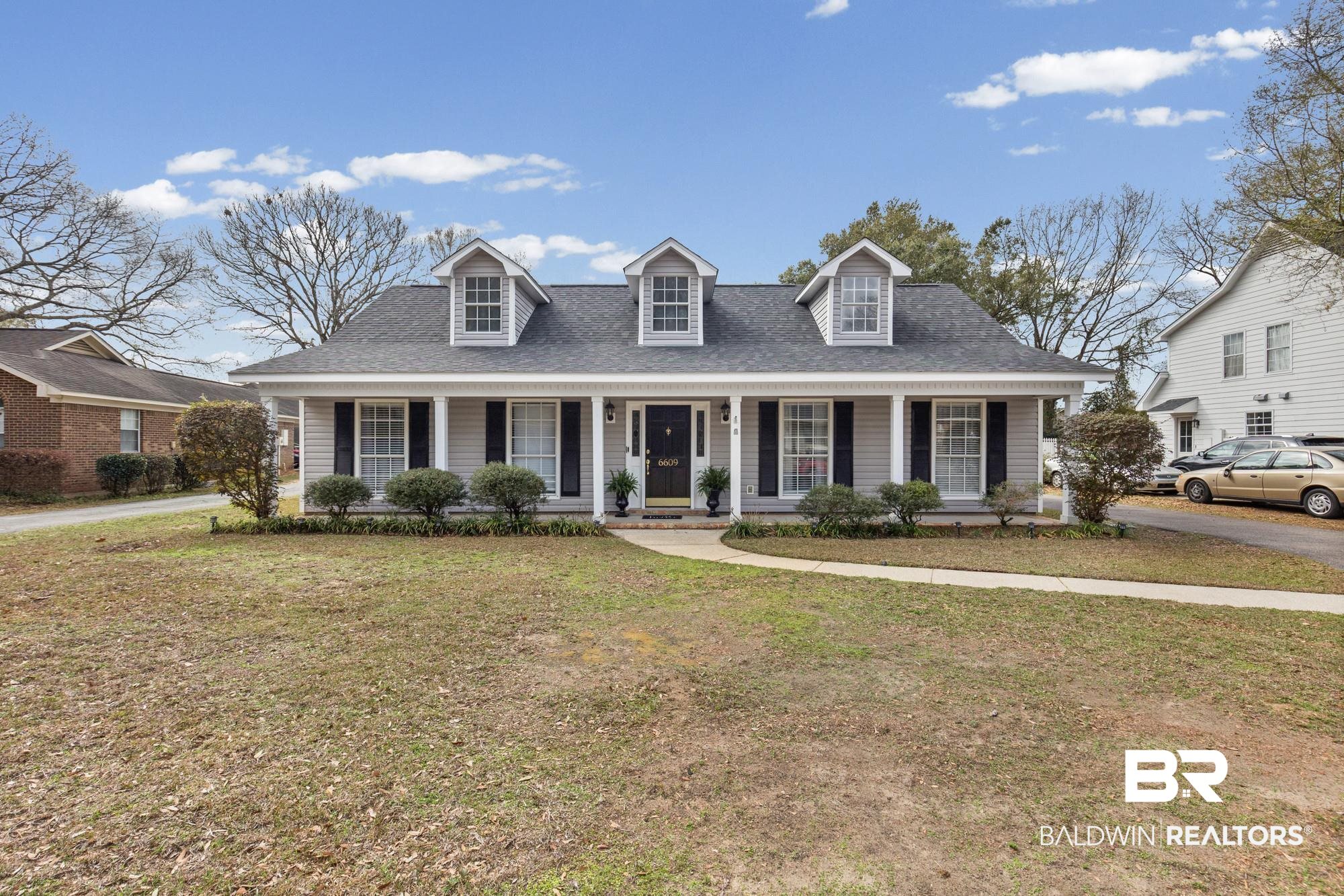 6609 Blakeley Court Mobile, AL 36695 - Photo 2 of 28 Cape cod-style house featuring a porch, roof with shingles, and a front yard