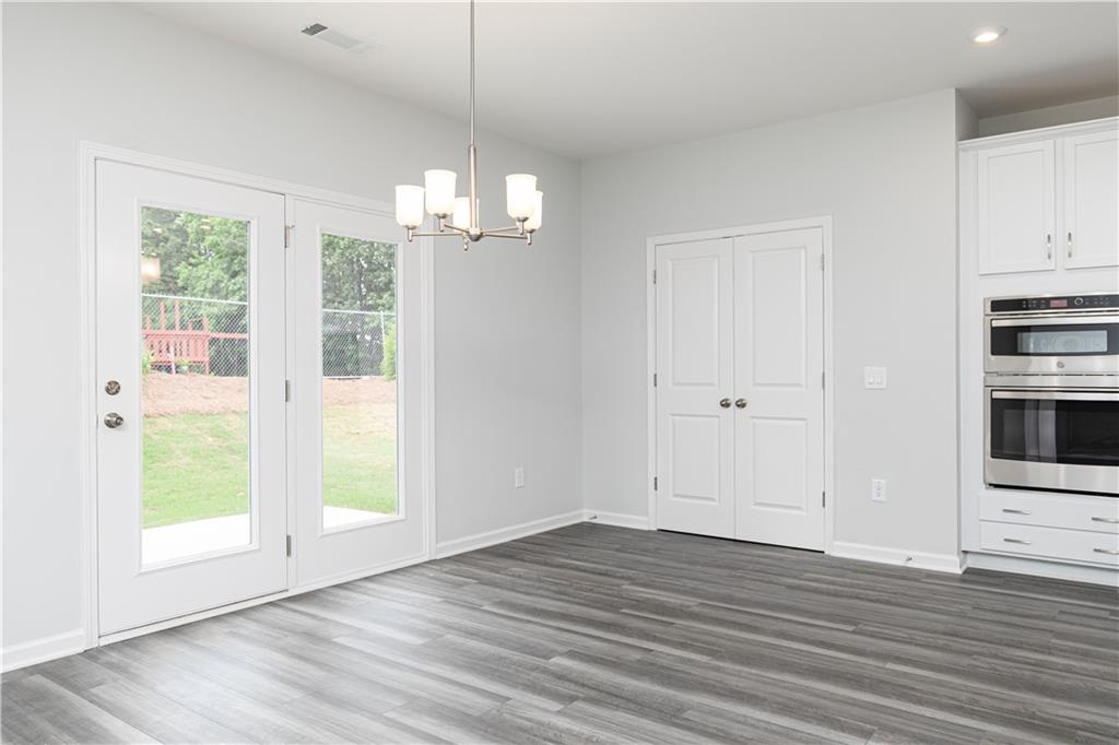 329 Cavalier Lane Acworth, GA 30102 - Photo 13 of 58 a view of empty room with wooden floor and window