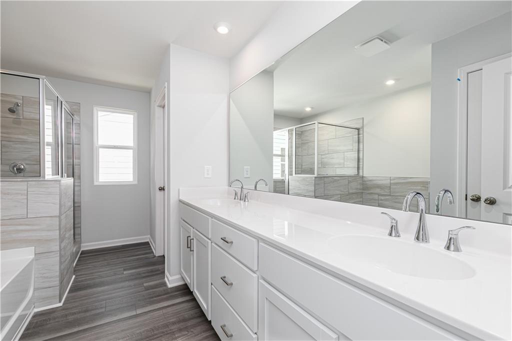 329 Cavalier Lane Acworth, GA 30102 - Photo 20 of 58 a bathroom with double vanity sinks and a large mirror